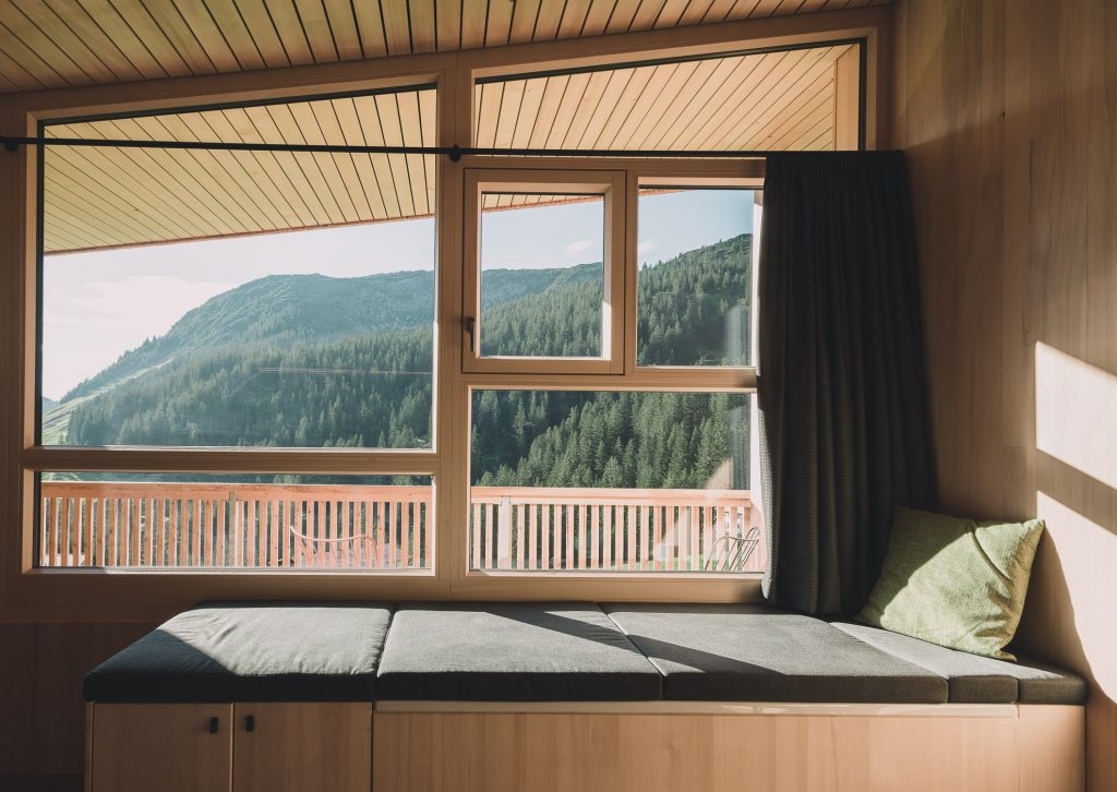 Hotelzimmer mit viel Holz mit Blick auf die Berge